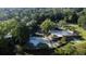 Aerial view of a community pool, tennis courts, clubhouse, and golf course, nestled among lush greenery at 143 Lablanc Nw Way, Atlanta, GA 30327