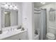 Clean bathroom featuring white vanity, a large mirror, shower, and stylish black and white checkered floor design at 143 Lablanc Nw Way, Atlanta, GA 30327