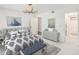 Inviting bedroom with natural light, modern light fixture, decorative art, and a adjoining bathroom providing comfort and style at 143 Lablanc Nw Way, Atlanta, GA 30327
