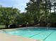 A sparkling community pool with multiple marked lanes surrounded by chairs and lush greenery at 143 Lablanc Nw Way, Atlanta, GA 30327