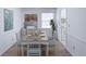 Bright dining room with classic decor, hardwood floors, a farmhouse dining table and access to the kitchen at 143 Lablanc Nw Way, Atlanta, GA 30327