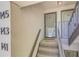 Condo entrance with unit numbers and stairs leading to glass-paneled door at 143 Lablanc Nw Way, Atlanta, GA 30327