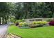 A well-manicured entrance sign adorned with colorful flowers welcomes residents and visitors at 143 Lablanc Nw Way, Atlanta, GA 30327