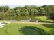 Aerial view of green putting range alongside a pond with woods at 143 Lablanc Nw Way, Atlanta, GA 30327