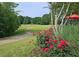 Beautiful golf course view with pink roses, red umbrella, and lush green fairway at 143 Lablanc Nw Way, Atlanta, GA 30327