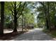 A quaint guard house sits at the entrance of the community, surrounded by lush greenery at 143 Lablanc Nw Way, Atlanta, GA 30327
