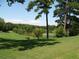 Beautiful serene view of the pond and lush green lawn at 143 Lablanc Nw Way, Atlanta, GA 30327