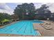 Large community pool with lounge chairs and meticulously maintained landscaping around the pool deck at 143 Lablanc Nw Way, Atlanta, GA 30327