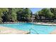 Enjoy the community pool surrounded by lounge chairs and lush trees at 143 Lablanc Nw Way, Atlanta, GA 30327