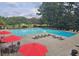 Large pool with lounge chairs and red umbrellas at 143 Lablanc Nw Way, Atlanta, GA 30327