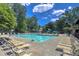 Resort-style swimming pool with plenty of lounge chairs, perfect for relaxing and enjoying the sunny weather at 143 Lablanc Nw Way, Atlanta, GA 30327