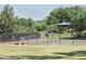 Well-maintained tennis court with lush greenery creating a private and serene playing environment at 143 Lablanc Nw Way, Atlanta, GA 30327