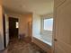 Bathroom featuring a large tub, ceramic tile flooring, and neutral colored walls at 3531 Lilly Brook Dr, Loganville, GA 30052