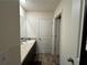 Bathroom features a dark wood vanity, sink, and tiled floors at 3531 Lilly Brook Dr, Loganville, GA 30052
