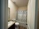 Bright bathroom featuring a granite vanity and shower-tub combination at 3531 Lilly Brook Dr, Loganville, GA 30052