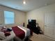 Bedroom featuring dark wood dresser, flat screen TV, and a bright window at 3531 Lilly Brook Dr, Loganville, GA 30052