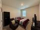 Cozy bedroom featuring a comfortable bed, recliner chair, and neutral carpeting at 3531 Lilly Brook Dr, Loganville, GA 30052