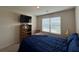 Bright bedroom featuring a flat screen TV and a window with natural light at 3531 Lilly Brook Dr, Loganville, GA 30052