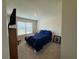 Cozy bedroom with a comfortable bed, bright window, and a dark wood end table at 3531 Lilly Brook Dr, Loganville, GA 30052