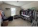 Spacious walk-in closet with ample storage, hanging racks, shelving, and a window for natural light at 3531 Lilly Brook Dr, Loganville, GA 30052