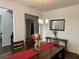 Cozy dining room boasting a rustic table with bench seating, and a charming chandelier at 3531 Lilly Brook Dr, Loganville, GA 30052