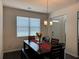 Cozy dining room boasting a rustic table, bench seating, and a charming chandelier at 3531 Lilly Brook Dr, Loganville, GA 30052