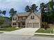 Beautiful two-story home featuring brick accents, a well-maintained lawn, and an attached two-car garage at 3531 Lilly Brook Dr, Loganville, GA 30052