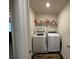 Functional laundry room with a modern washer and dryer set and storage shelving at 3531 Lilly Brook Dr, Loganville, GA 30052