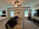 Bright living room featuring a ceiling fan, carpeted floors, and great natural lighting at 3531 Lilly Brook Dr, Loganville, GA 30052