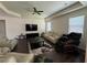 Airy living room with wood floors, ceiling fan and neutral colors to make the room seem even more roomy at 3531 Lilly Brook Dr, Loganville, GA 30052