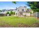 Grassy backyard with a wooden deck, backing up to a two-story home with mature trees at 3550 Willow Tree Trce, Decatur, GA 30034
