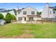 A large, grassy backyard features a wooden deck and fence, backing up to a two-story home at 3550 Willow Tree Trce, Decatur, GA 30034