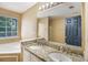 Bathroom featuring double sinks with granite countertop and large mirror with overhead lighting at 3550 Willow Tree Trce, Decatur, GA 30034