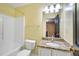 Bathroom with granite countertops, bathtub and a view of the hallway at 3550 Willow Tree Trce, Decatur, GA 30034