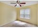 Bedroom featuring a ceiling fan and neutral walls complemented by natural light from the window at 3550 Willow Tree Trce, Decatur, GA 30034