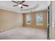 Bedroom with tray ceiling, neutral carpet, and two windows at 3550 Willow Tree Trce, Decatur, GA 30034