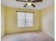 Bedroom featuring a ceiling fan and neutral walls with natural light from the window at 3550 Willow Tree Trce, Decatur, GA 30034