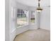 Bright dining area with bay window, carpet, and elegant chandelier at 3550 Willow Tree Trce, Decatur, GA 30034