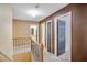Hallway with wood railing and multiple doors with views of rooms and bathroom at 3550 Willow Tree Trce, Decatur, GA 30034