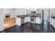 Well-lit kitchen with stainless steel appliances, granite countertops, and black tile floor at 3550 Willow Tree Trce, Decatur, GA 30034