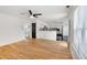 Open-concept living room with adjacent kitchen, wood flooring, and lots of natural light at 3550 Willow Tree Trce, Decatur, GA 30034