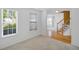 Bright living room with large windows, carpeted floors, and view of the staircase at 3550 Willow Tree Trce, Decatur, GA 30034
