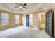 Spacious main bedroom with a ceiling fan and large windows providing natural light at 3550 Willow Tree Trce, Decatur, GA 30034
