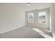 Bedroom with neutral carpet, light walls, and natural light from two windows at 4517 Twinberry Dr, Powder Springs, GA 30127