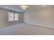 Spacious bedroom with a large window, carpet, and recessed lighting at 4517 Twinberry Dr, Powder Springs, GA 30127