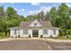 View of the community center with gray trim, white exterior, and an arched entry with black metal gate at 4517 Twinberry Dr, Powder Springs, GA 30127