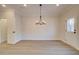 Open dining area features modern light fixture and connects seamlessly to other rooms at 4517 Twinberry Dr, Powder Springs, GA 30127