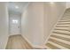Bright entryway boasting wood-look floors, a staircase, and a white front door at 4517 Twinberry Dr, Powder Springs, GA 30127