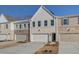 The exteriors of new townhomes with neutral colors, complemented by well-maintained driveways at 4517 Twinberry Dr, Powder Springs, GA 30127