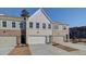 Beautiful new townhomes with a mix of brick and siding, complemented by pristine concrete driveways at 4517 Twinberry Dr, Powder Springs, GA 30127
